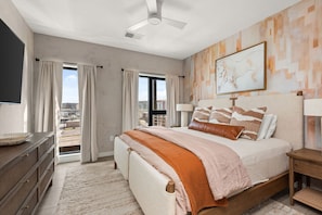 Third Bedroom: Queen-size bed with smart TV and ensuite bathroom with double vanity.