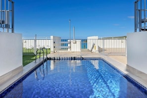 Retreat to the building's rooftop pool, offering beautiful waterfront views.