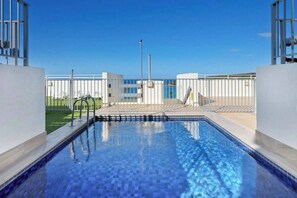 Retreat to the building's rooftop pool, offering beautiful waterfront views.
