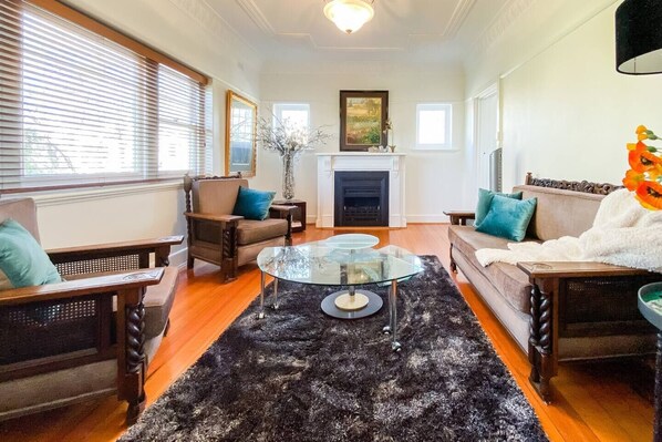Ornate details, rustic timber flooring and antique furnishings highlight the apartments original Victorian style.