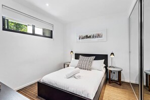 The bedroom is modern and comfortable, featuring a double bed and plenty of storage for your belongings.