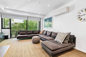 Floor-to-ceiling windows reveal leafy views and allow the natural light to pour in.