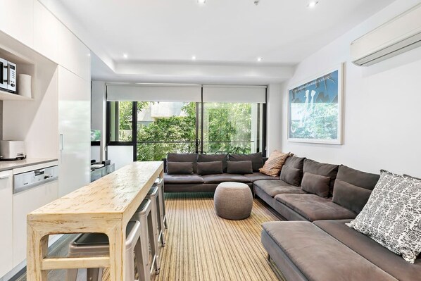 The living room boasts an oversized L-shaped lounge with plenty of room to spread out.