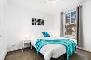 The first bedroom sleeps two in a queen bed, offering plenty of storage and a ceiling fan to keep you cool.