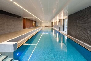 Swim laps in the shared indoor swimming pool