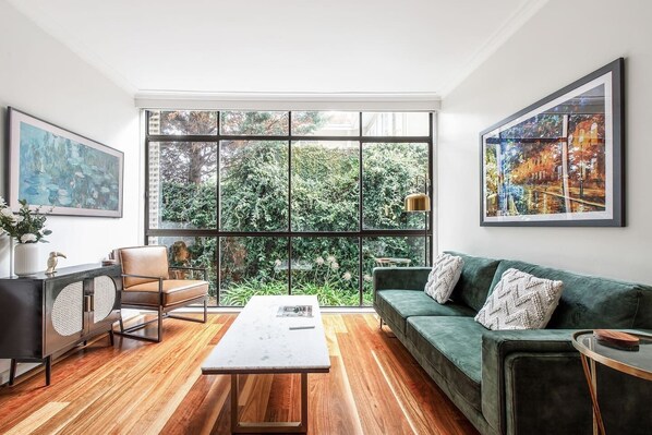 The light-filled living space opens out to a comfortably furnished balcony, providing s cosy spot to enjoy your morning coffee or a glass of wine at sunset.  
