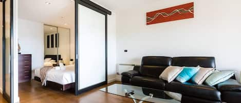 The bedroom offers privacy with a sliding door closing it off to the main living area.