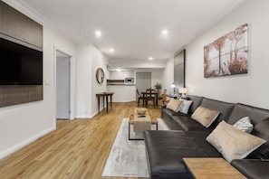 The open plan apartment includes a four-seater dining table and lounge area.