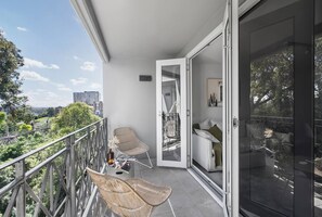 A private balcony offers the perfect spot to enjoy your morning coffee in the sun.