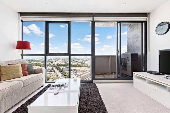 Enjoy sprawling views across the CBD from the comfort of your plush couch.