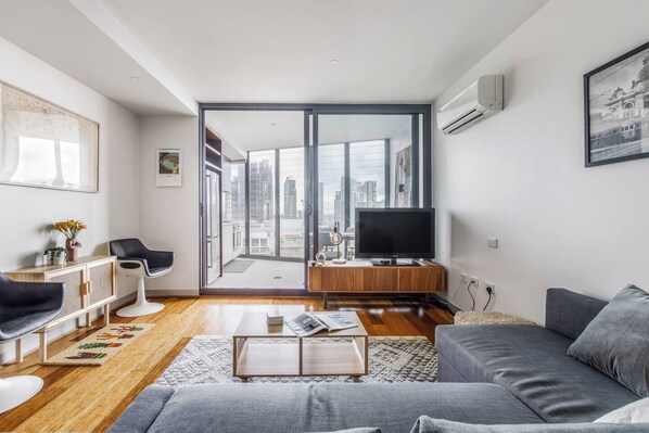 The living space is equipped with split-system heating and cooling and extends out to the undercover balcony through sliding glass doors.