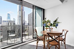 Dine together at the four-seater table, overlooking views of the Melbourne skyline.