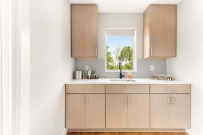 Natural light and modern cabinetry meet boutique charm.