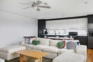 Neutral textures and a fully equipped kitchen in one inviting space.