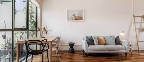 The living and dining area is open plan and flows to the balcony, filling the space with beautiful natural light.
