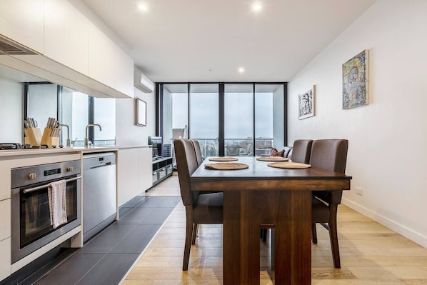 Enjoy meals at home on this stylish hardwood dining table and high back chairs that comfortably seats four. 
