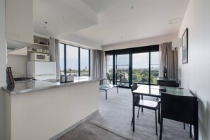 The open-plan dining area includes a well-euipped kitchen and a three-seater table.
