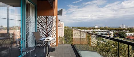A private corner balcony offers spectacular views of the city and coast. 
