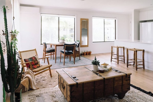 Bright and breezy, this apartment showcases an open-plan layout extending to a sunny balcony with bench seating.