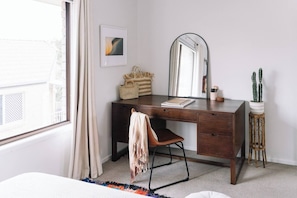 The master bedroom has a queen-sized bed, built-in wardrobe, ceiling fan and study desk for those travelling on business.