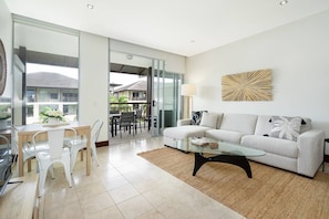 The open plan living area extends to a sunny balcony, replete with outdoor furniture to enjoy an alfresco meal.


