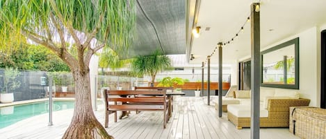  The spacious undercover deck is comfortably furnished to make the most of long, balmy days, with an outdoor dining table and an array of sofas and armchairs for you to kick back and relax.

