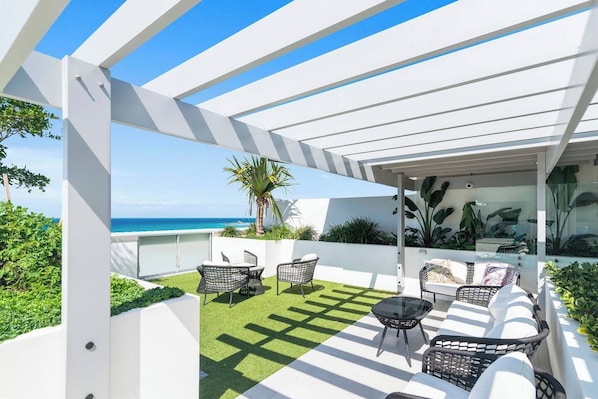 Take in the coastal charm from our shared rooftop, where comfortable seating and ocean vistas make for a perfect escape.