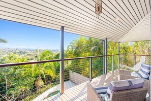 The wraparound deck overlooks the gardens and has seating areas as well as a BBQ.
