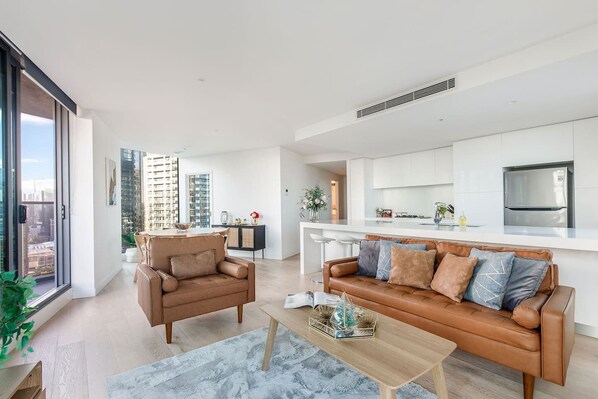 Soak up the city views from this sunlit living area, complete with leather seating and a smart TV for easy evenings in.