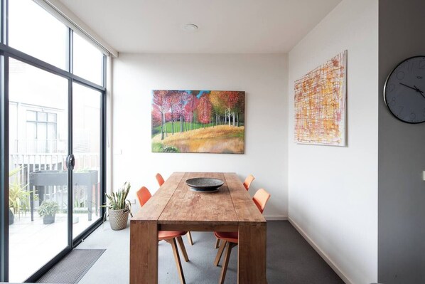 The four-seater dining table provides the perfect spot to enjoy meals or use as a workspace for those last-minute emails, with the added bonus of easy balcony access for a breath of fresh air whenever you desire.
