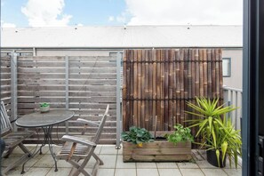 The balcony offers a cosy two-seater setting to enjoy an evening drink before heading to dinner.