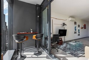 The living room flows out to a private balcony with a charming two-seater table to enjoy an alfresco meal. 