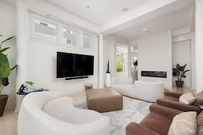 Living Area surrounds a Large Flat Screen TV