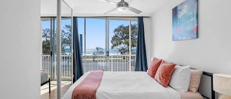 The light and airy first bedroom offers a queen bed and ocean views, as well as direct access to the balcony. 
