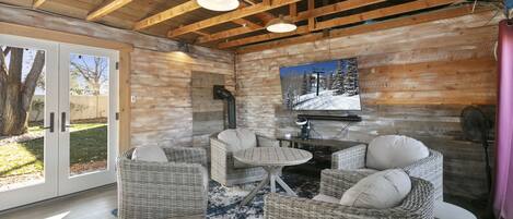 One of two outbuildings on the property, the cute red barn contains a spacious mancave with big screen TV, gaming console, bistro seating and ping pong table.
