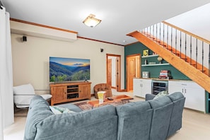 Enjoy the lower level rec room with a huge TV, wine fridge and more