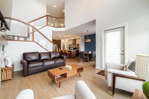 Open-concept layout with modern kitchen, stylish dining, and cozy living space.