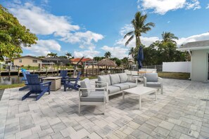 The open, paved pool deck is thoughtfully furnished for your family to enjoy every minute spent outside.