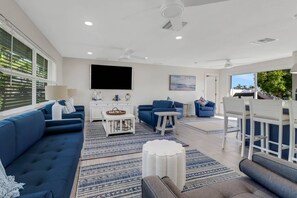 The open concept main living space is bright and cheerful - a great gathering spot for your family and friends.