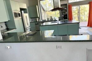  kitchen counters with the stove, microwave, oven, kettle, and other essentials.