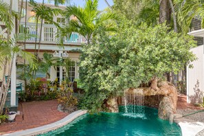 The Main House has access to a lush pool area, complete with a waterfall and grotto!