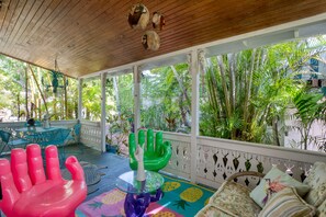 Bright and energetic covered patio lounge. (Main House)