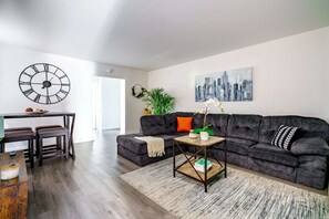Downtown Columbus Airbnb; Refined Comfort in a Bright Space Unwind in our elegant living room, filled with bright, natural light and plush seating. The clean and spacious area offers the perfect environment for relaxation. Immerse yourself in the refined and inviting atmosphere