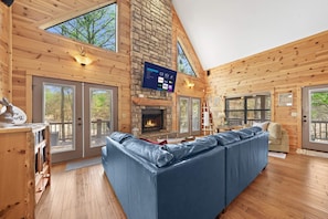 The living room includes a comfortable sofa, a flat-screen Smart TV, and a spacious layout.
