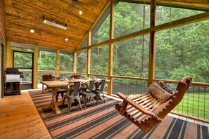 Over-sized screened porch with a double swing and a creek view plus overhead heaters for year-round enjoyment