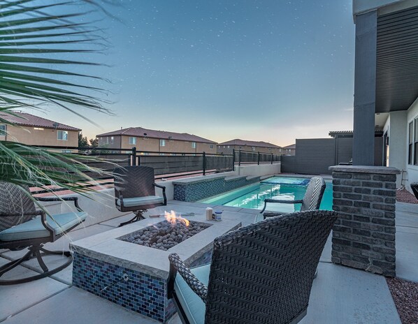 Pool area with comfortable seating, firepit and lounging area
