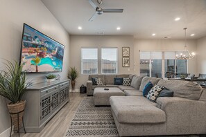 Large living room with lots of seating and large TV