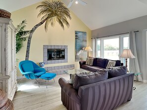 The living area with a fireplace and access to the outdoor patio