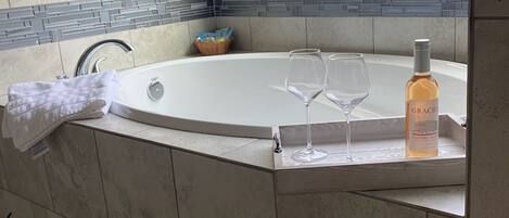 Enjoy a relaxing soak in the tub with a glass of wine.