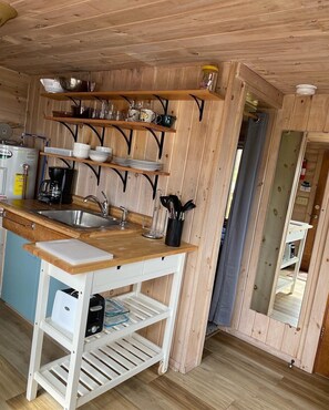 Open shelving in the kitchen and plenty of hot water! So please excuse the monster hot water heater.